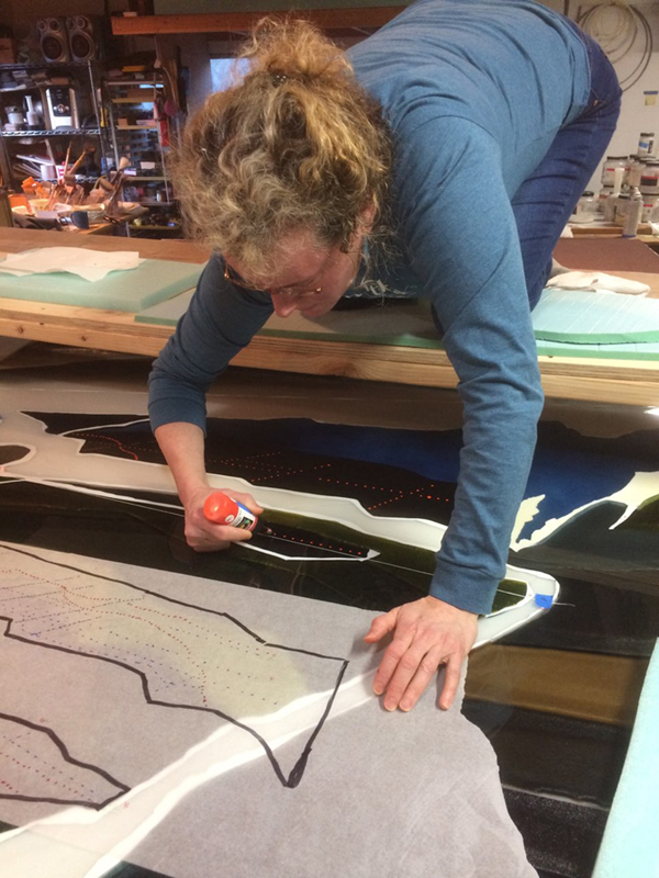 Alex Hirsch applying dots using vitreous enamels onto fused glass surface