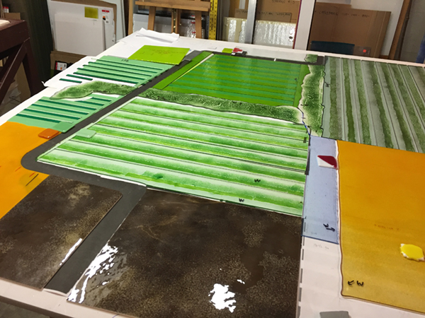 prefused elements and sheet glass being cut and assembled